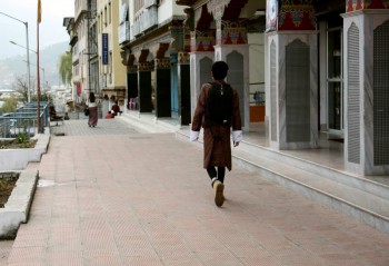 bp-1-thimphu-street On Thimphu street, a man wearing the traditional 'goh' for men.